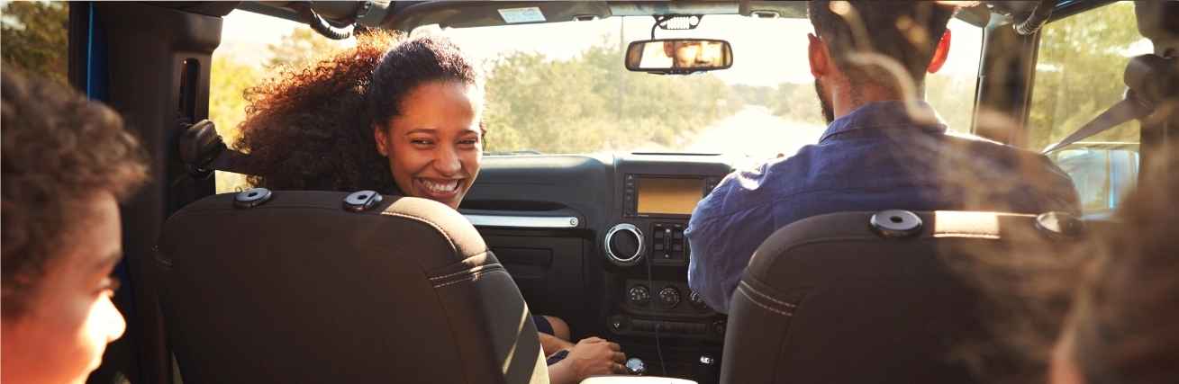 Family laughing sitting in a car